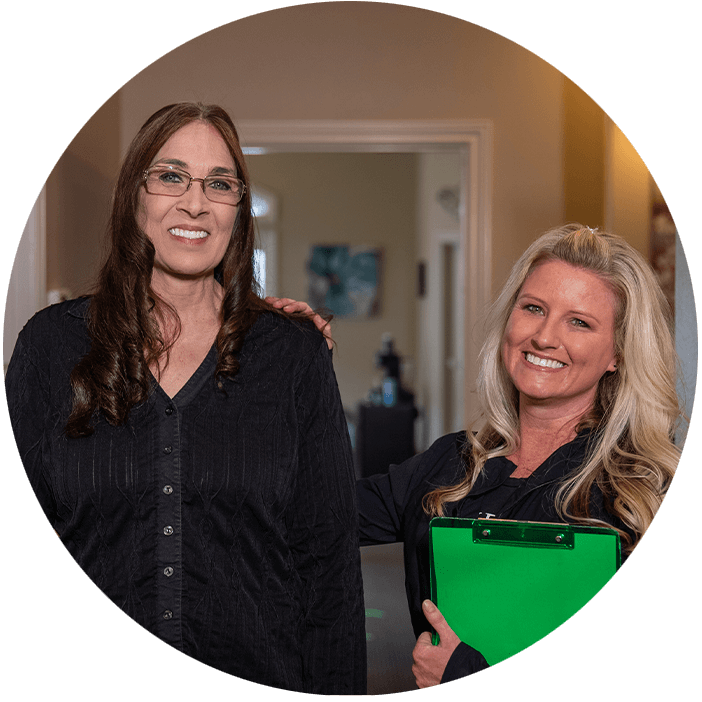 team member and doctor standing together smiling