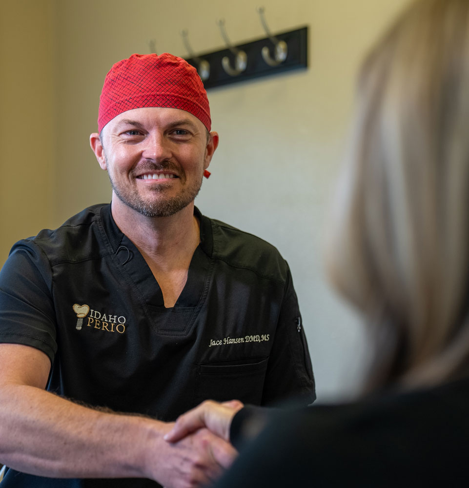 dr hansen member shaking patients hand smiling