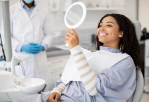 Periodontist explains gum disease differences to a patient in a dental office.