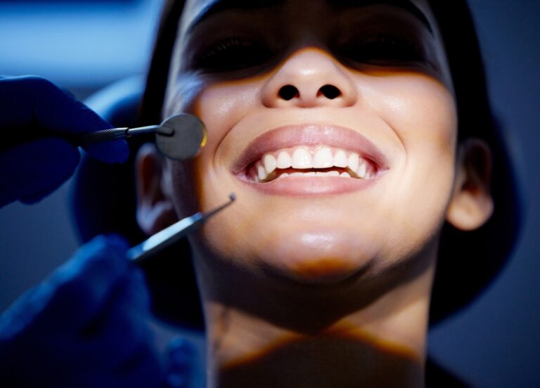 Periodontist with patient discussing gum infection treatment in a dental office